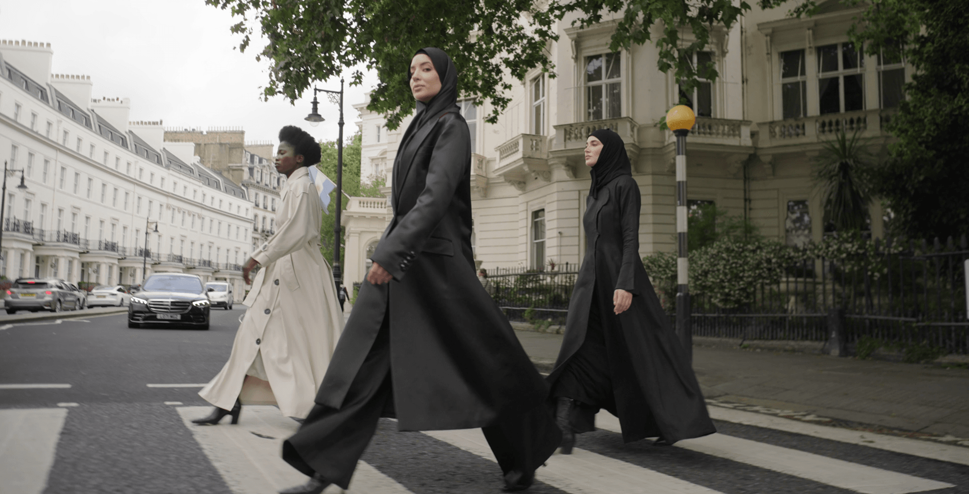 Three women in stylish outfits walking